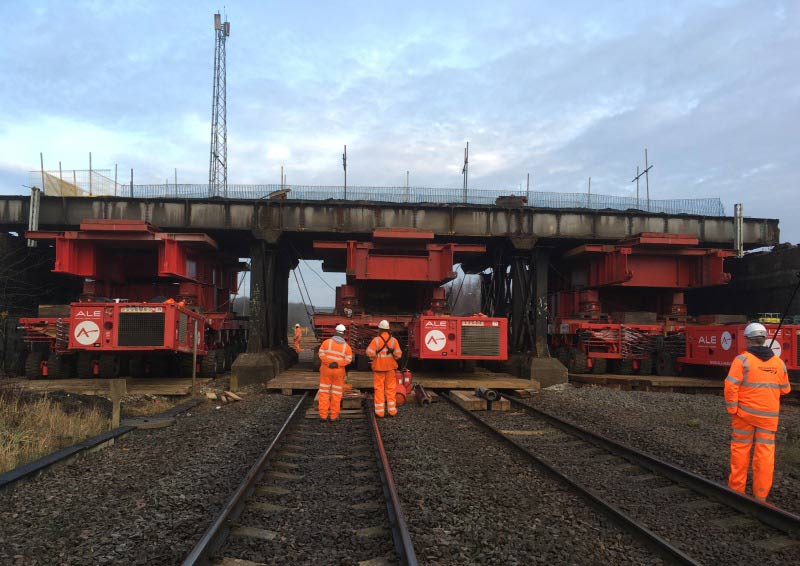 Old bridge being lifted out using three SPMT's